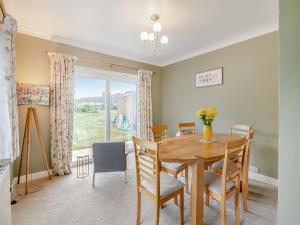 a dining room with a table and chairs and a window at Moor Close in Alne