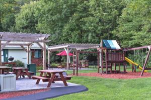 a park with picnic tables and a playground at Adirondack Sunrise Lodge in Lake George