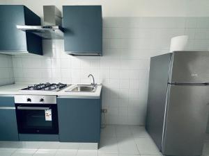 a kitchen with a sink and a refrigerator at Siliade Apartment in Montesilvano