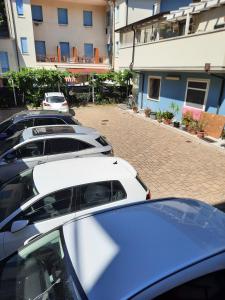 Hotel Ambra في تشيزيناتيكو: صف من السيارات المتوقفة في موقف للسيارات