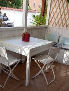 a white table and two chairs on a porch at Sa Frummiga in Cagliari