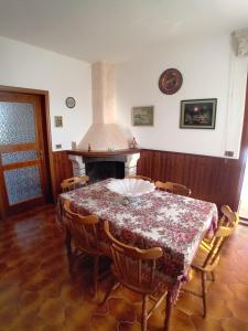 a dining room with a table and a fireplace at DA GIANNì in Nereto