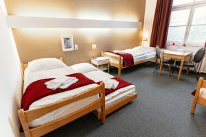 Кровать или кровати в номере Tagungs und Gästehaus St Georg