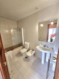 a bathroom with a sink and a toilet and a sink at Apartamento SEA VIEW Celeste Costa del sol Playa Chapparal in Mijas Costa