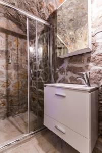 a bathroom with a sink and a shower at Rodia Eco stay house in Epidavros - Akros Estate in Nea Epidavros