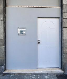 a white door in a building with a sign on it at BeTurin in Turin