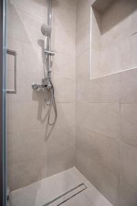 a bathroom with a shower with a glass door at Piraeus port 1 bedroom 2 persons apartmet by MPS in Piraeus