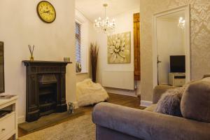 a living room with a couch and a fireplace at Cosy Corner Cottage - Simple2let Serviced Apartments in Halifax
