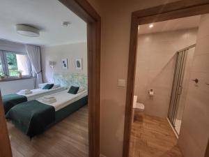 Posteľ alebo postele v izbe v ubytovaní Apartamenty Willove Wzgórze