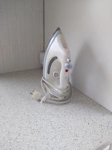 a toilet in a bathroom with a hose on the floor at Central Microflat, free parking, garden BBQ, LegoHouse, Legoland, in Billund