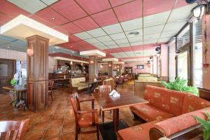 a restaurant with a table and chairs and a bar at Royal Beach in Golden Sands