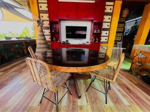 a dining room table with chairs and a microwave at Delia's Guest House in Mactan