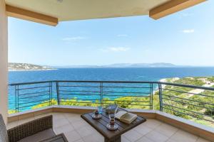 a balcony with a table and a view of the ocean at Seascape 3 Bedroom House in Schinias