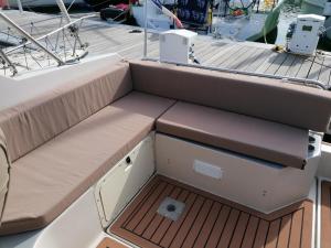 a seat on a boat with a wooden deck at Dormir sur un yacht insolite in La Rochelle
