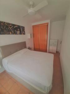 ein Schlafzimmer mit einem großen weißen Bett in einem Zimmer in der Unterkunft Casa mis Nietas in San José