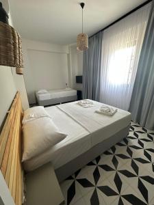 a bedroom with a large bed and a window at Arcadia Butik Otel in Canakkale