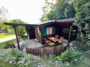 a cabin with a table and chairs in the yard at Campingplatz Mittagsspitze in Triesen