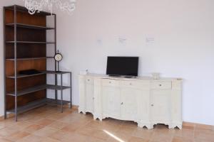a white cabinet with a television on top of it at La casa di Dani in Lanciano