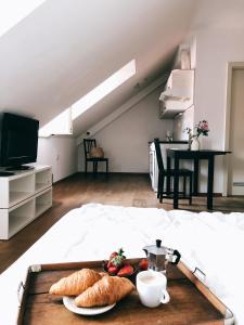 a tray of bread and croissants on a bed at Layer Residences in Kranj