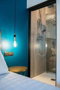 a room with a shower with a bed and a table at BeTurin in Turin +94 photos