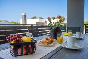 a table with a tray of food and a bowl of fruit at Domus Alba Apartments in Pula