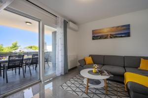 a living room with a couch and a table at Domus Alba Apartments in Pula