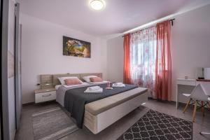 a bedroom with a bed and a red curtain at Domus Alba Apartments in Pula +46 photos