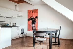 a dining room with a table and chairs in a kitchen at Layer Residences in Kranj