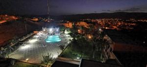 a view of a swimming pool at night at Hotel Saghro in Tinerhir