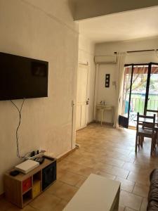 a living room with a flat screen tv on the wall at Le Pêcheur in Cassis