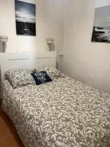 a bed with two pillows on it in a bedroom at Le Pêcheur in Cassis