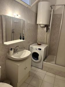 a bathroom with a sink and a washing machine at Le Pêcheur in Cassis