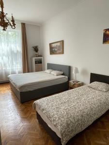 a bedroom with two beds and a window at Family Home in Budapest
