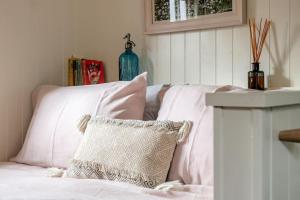 a white bed with a pillow on top of it at The Rumple Hut in Wingfield +40 photos