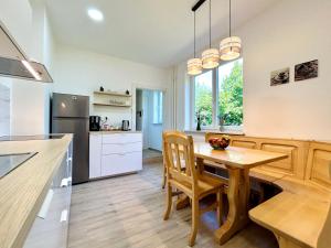a kitchen with a wooden table and chairs and a counter at Creekside House K in Mozirje