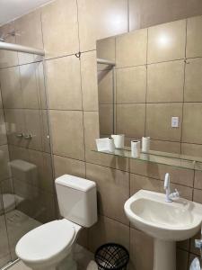 a bathroom with a toilet and a sink at Sobradinho Hotel in Sobradinho