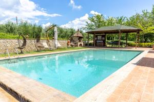 a swimming pool with a gazebo and a playground at Il Rifugio Del Falconiere in Sovicille