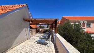 a patio with awning next to a building at Apartment 39 in Vir