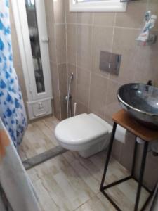 a bathroom with a toilet and a sink at Monastir cap Marina in Monastir