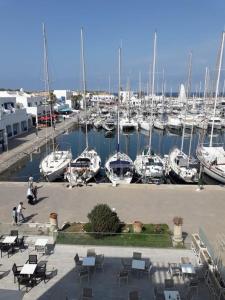 a marina with boats in a harbor with tables and chairs at Monastir cap Marina in Monastir