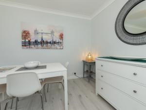 a bedroom with a white desk and a mirror at Pass the Keys 2BDR Peaceful Ground Floor Apartment Free Parking in Wokingham