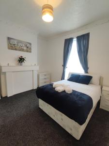 a bedroom with a large bed with a window at A&A Luxury Stay Noble Street in Sunderland