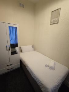 a bedroom with a bed with two towels on it at A&A Luxury Stay Noble Street in Sunderland