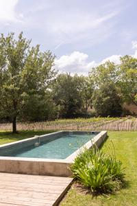a swimming pool in a yard with a fence at La Bergerie in Argelès-sur-Mer