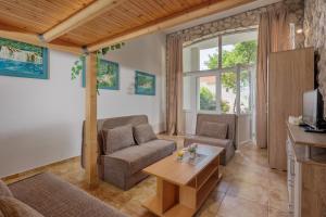 a living room with a couch and a table at Apartments TOMMI in Dramalj