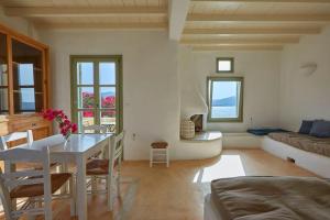 a living room with a table and a couch at Ochre Dream, Beach front & Sunset villa Naousa in Naousa