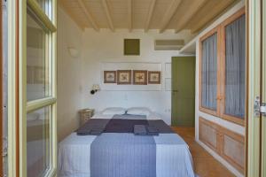 a bedroom with a large bed in a room at Ochre Dream, Beach front & Sunset villa Naousa in Naousa