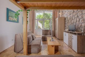 a living room with a couch and a table at Apartments TOMMI in Dramalj