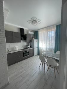 a kitchen with a table and chairs in a room at Nika apartment in Odesa