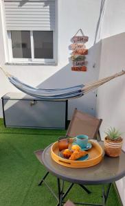 a tray of food on a table with a hammock at Casa Papillon in Sagres